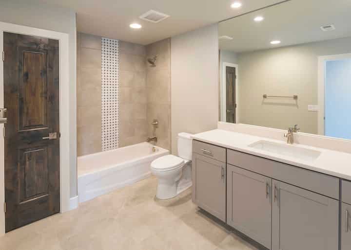 A new bathtub and shower installation adds functionality to a Deerfield Beach home;s bathroom.